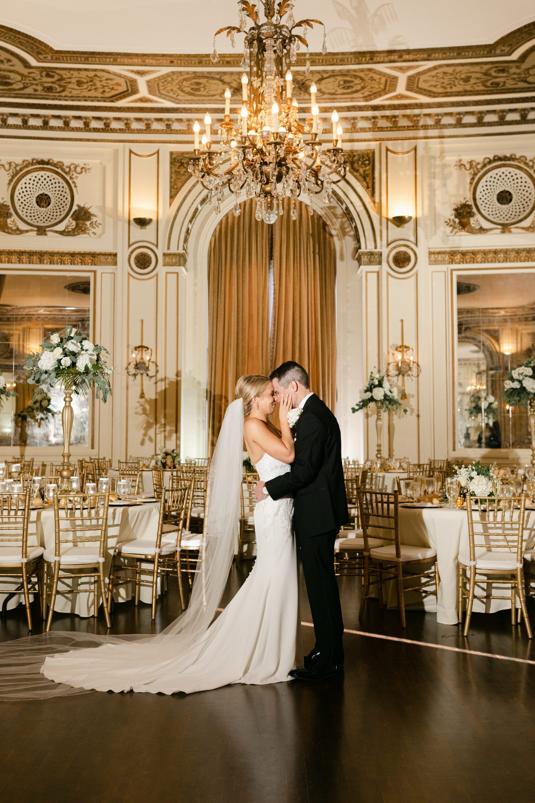 Bride and Groom with a portrait in their venue space Colony Club by Michele Maloney Photography