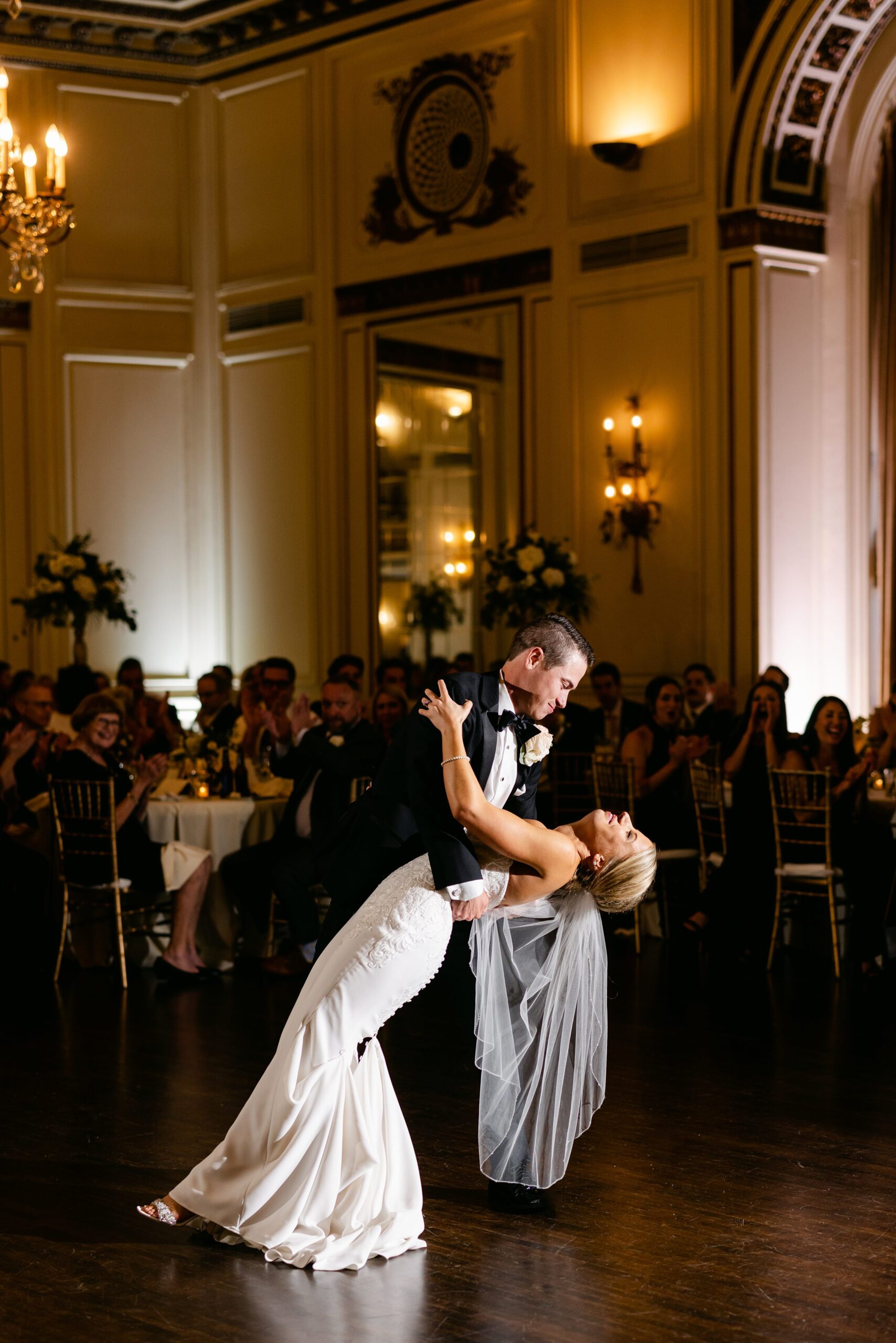 Groom dips bride during their first dance at the Colony Club by Michele Maloney Photography