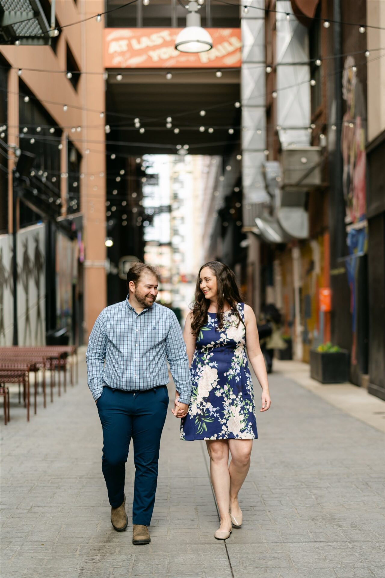 Brian and Jennifer walking hand in hand during their Detroit engagement session.