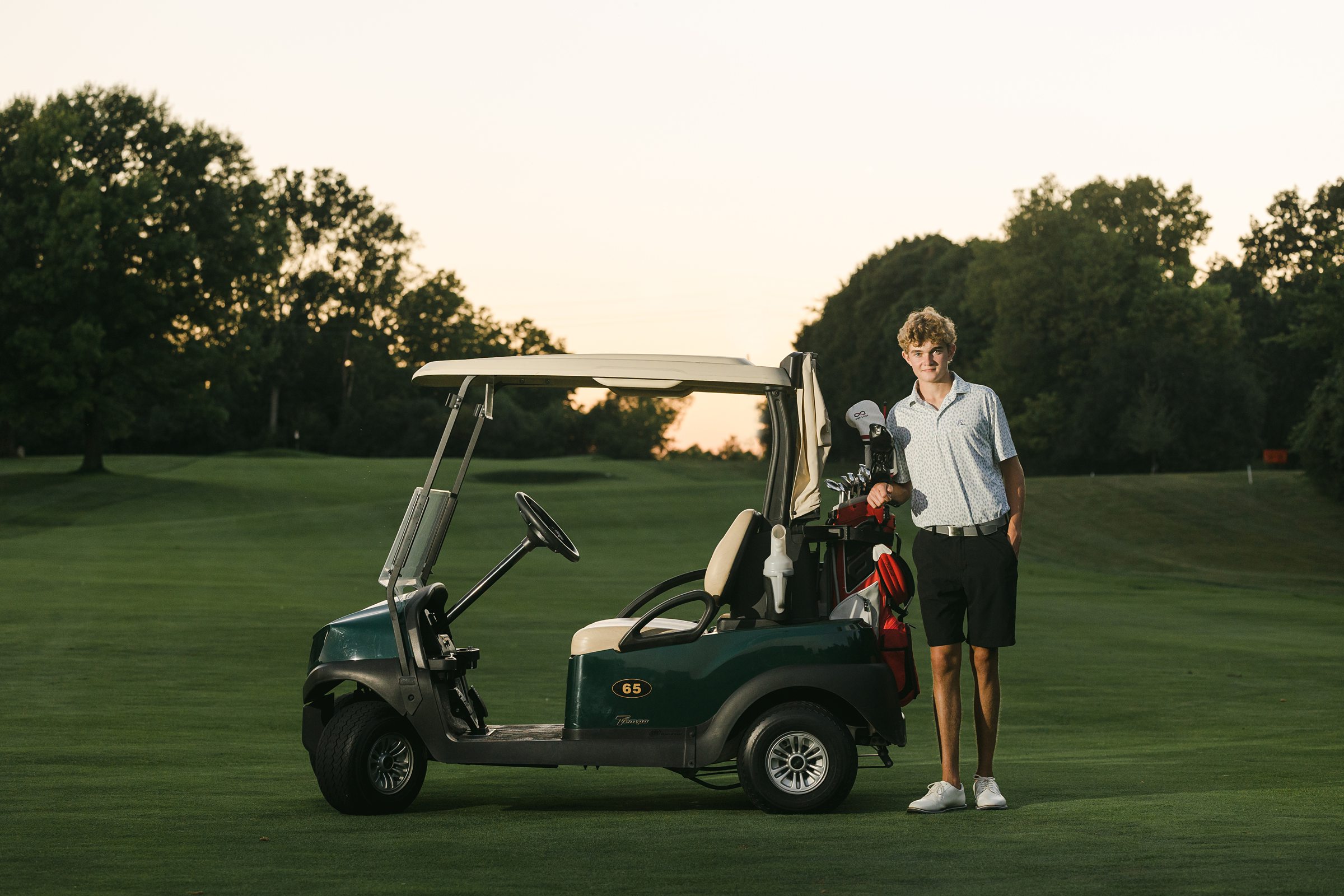 Senior boy with golf cart on at the Grosse Ile Country Club by Michele Maloney Photography