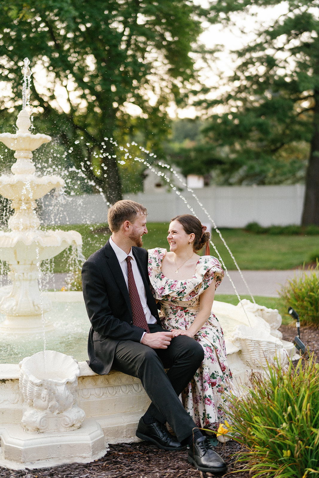 Peter and Cecilia smiling at each other in the Addison Oaks garden.