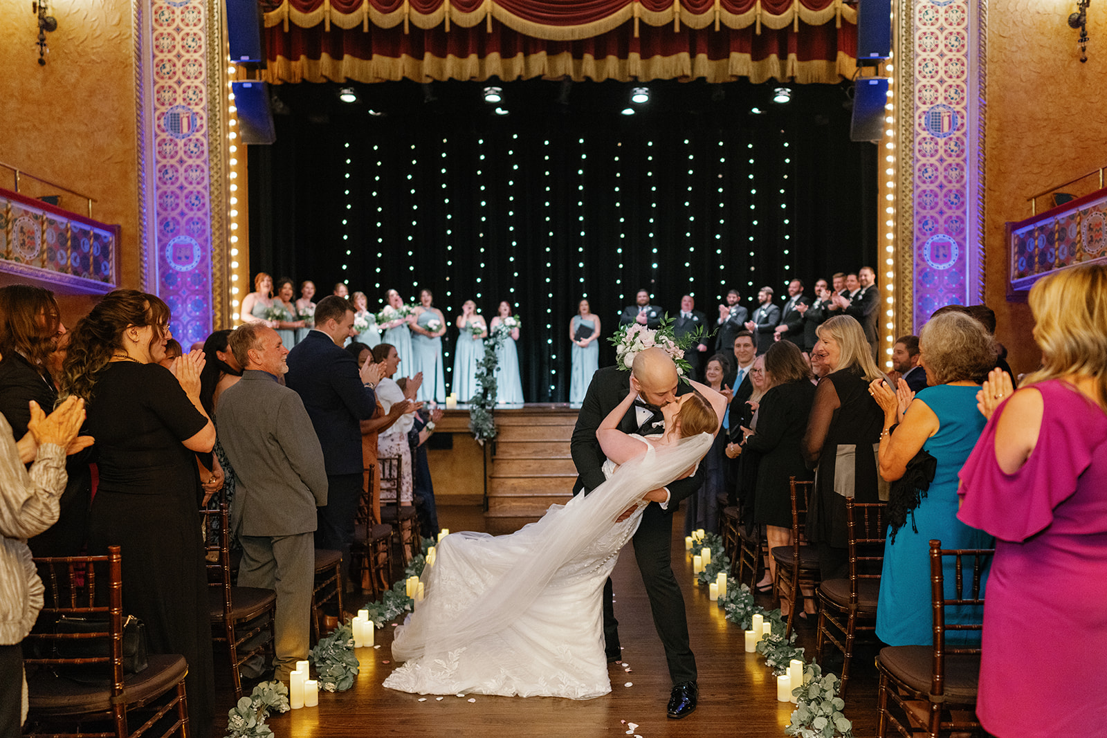Aubrey and Alex sharing a kiss during their June wedding at Gem Theatre.