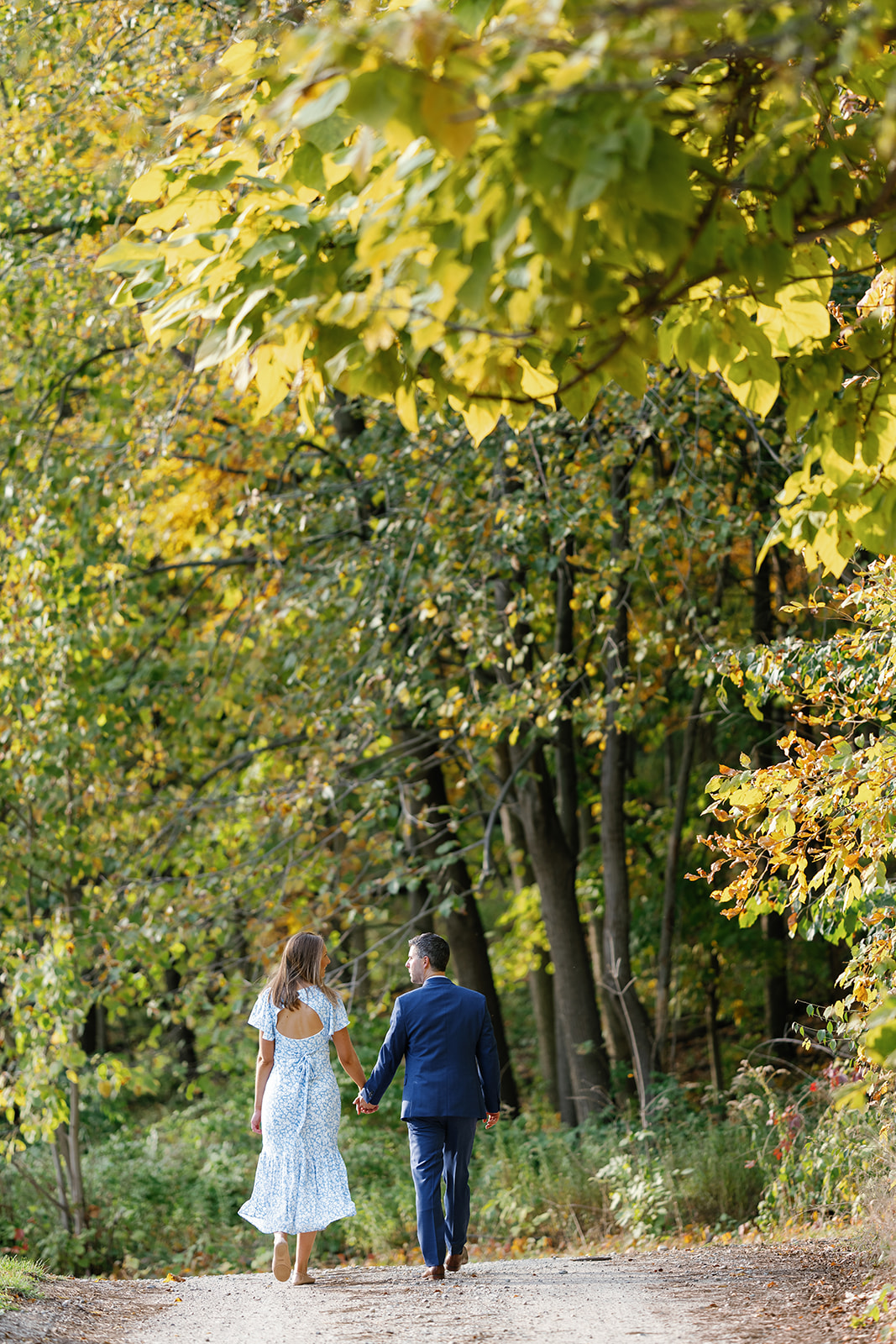 Couple smiling while walking hand in hand during their Island Park Engagement.