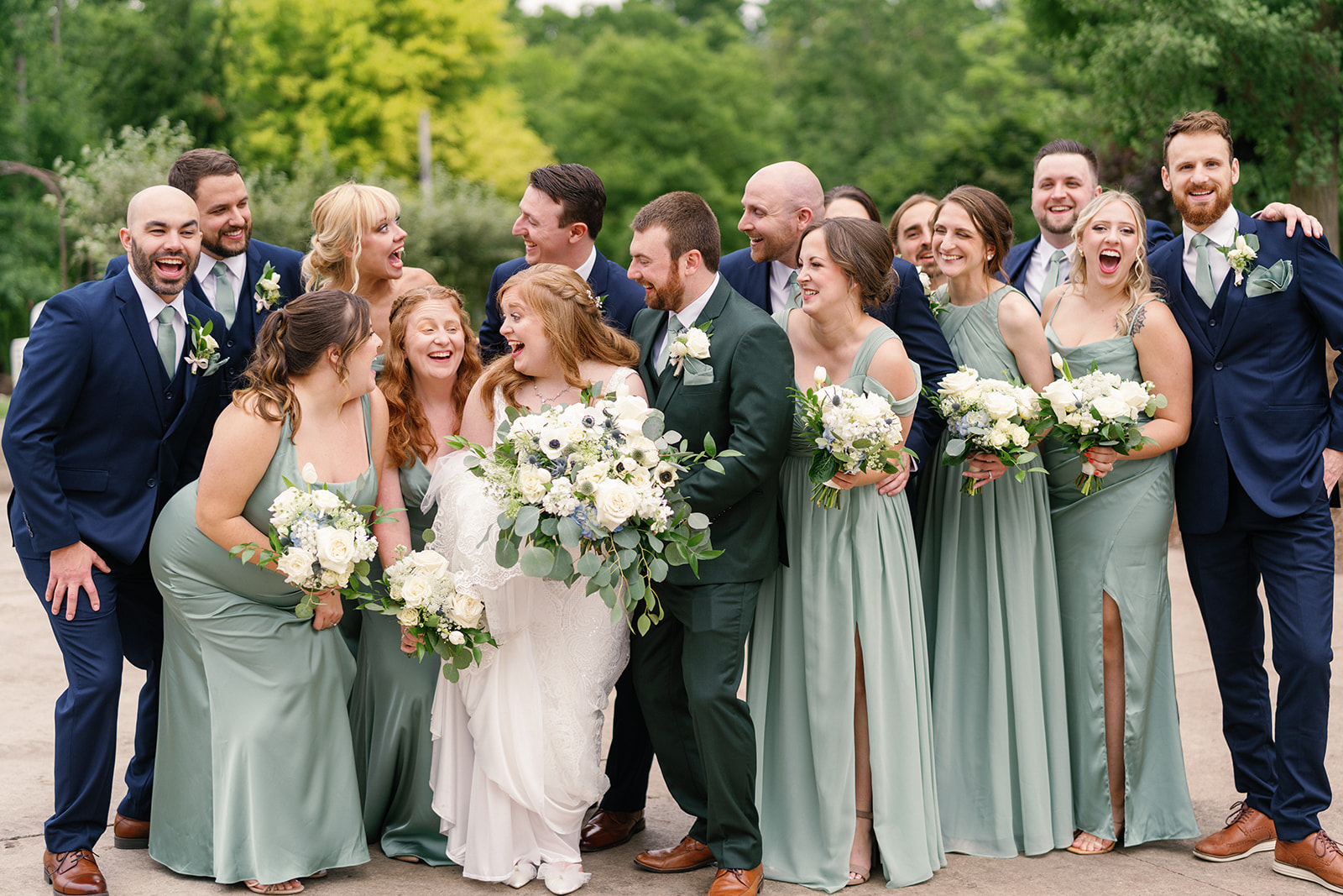 Elyse laughing with bridesmaids in matching Azazie dresses at The Treasury