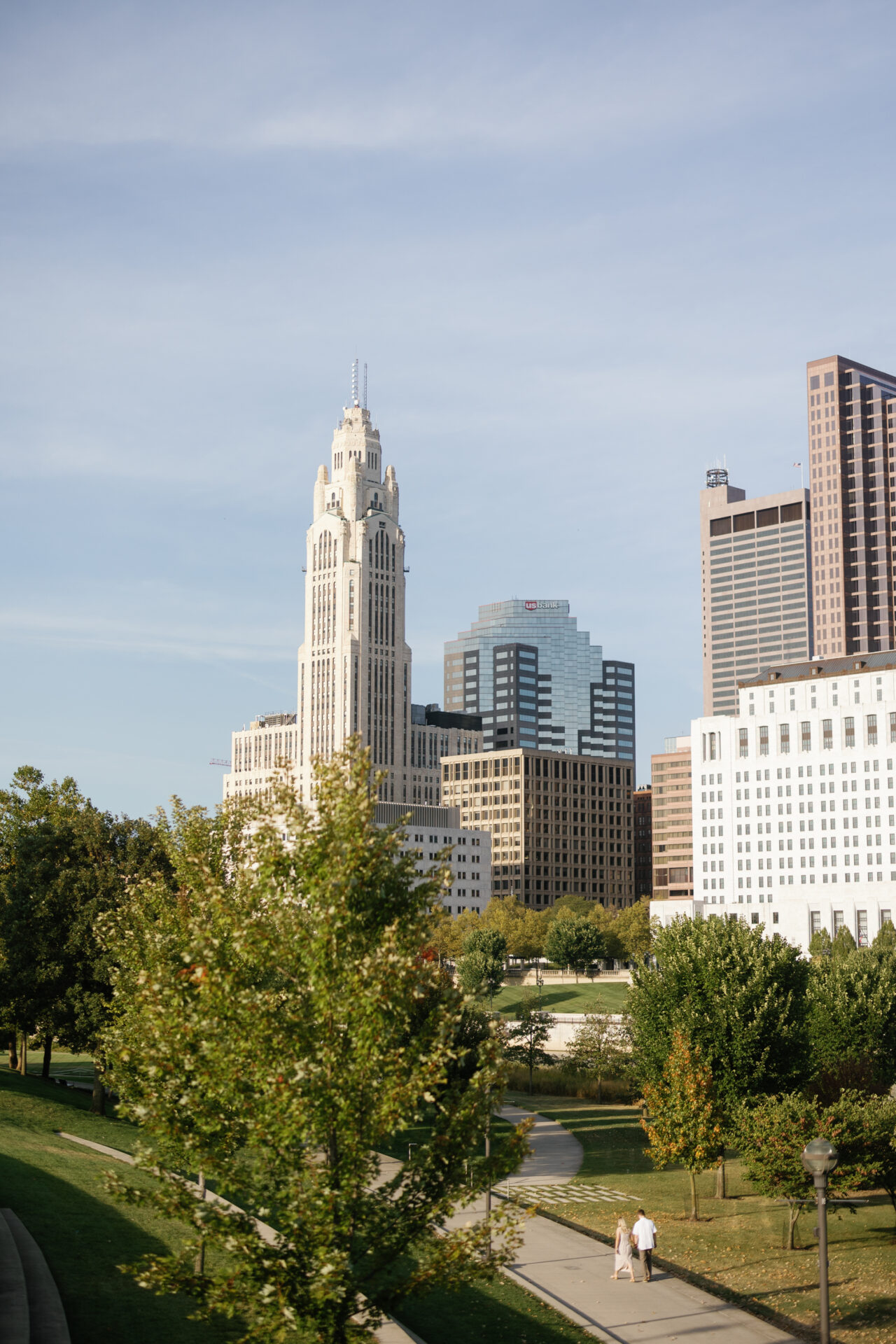 Couple walking hand in hand through Bicentennial Park in downtown Columbus.