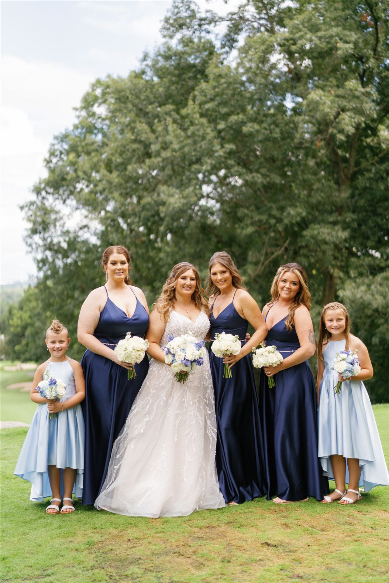 Bridal party portraits in front of the carriage house during the Summer Pine Knob Carriage House Wedding