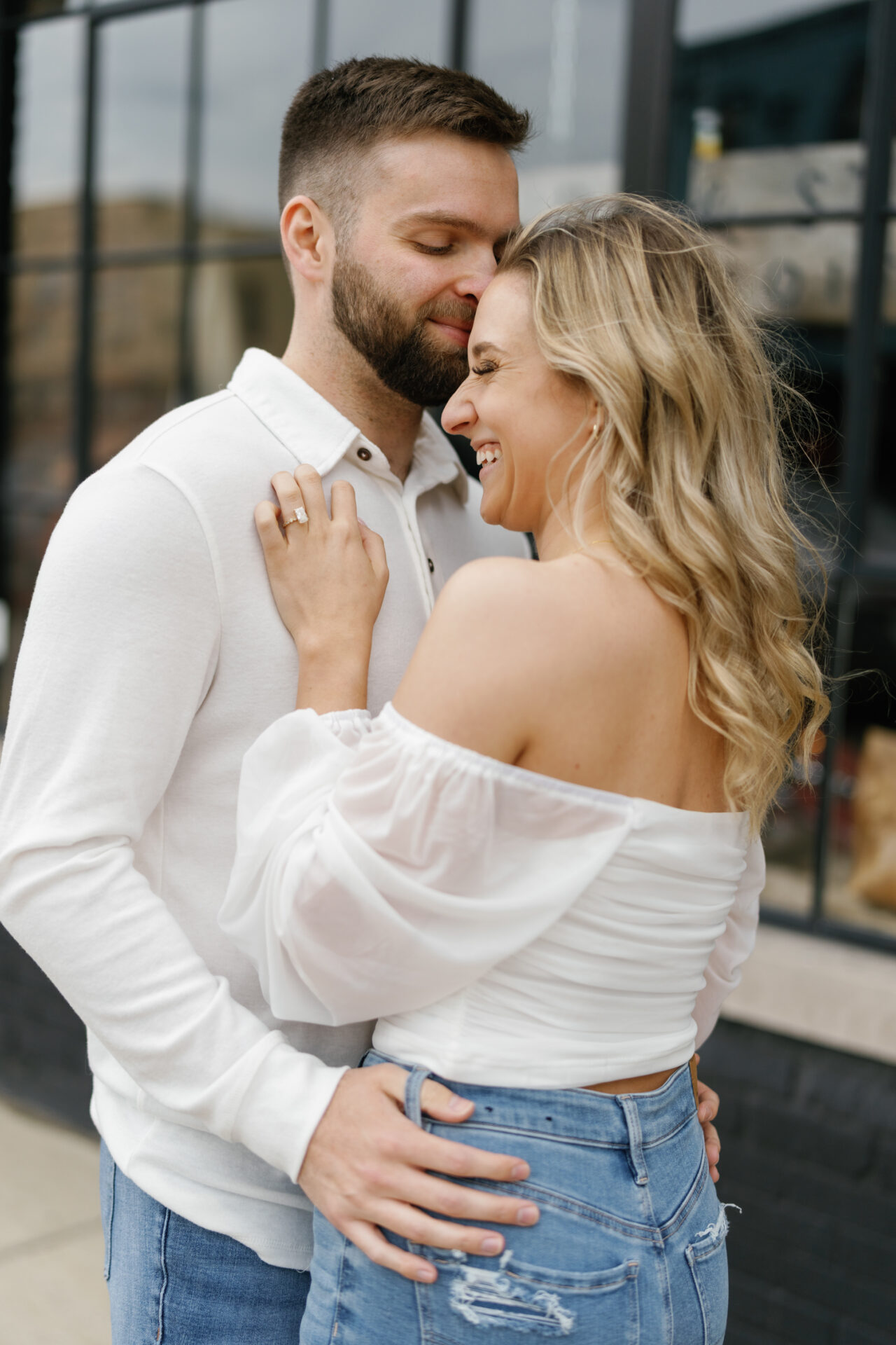 Jessica and Jordan snuggling on Michigan Avenue during their Michigan Central Engagement Session