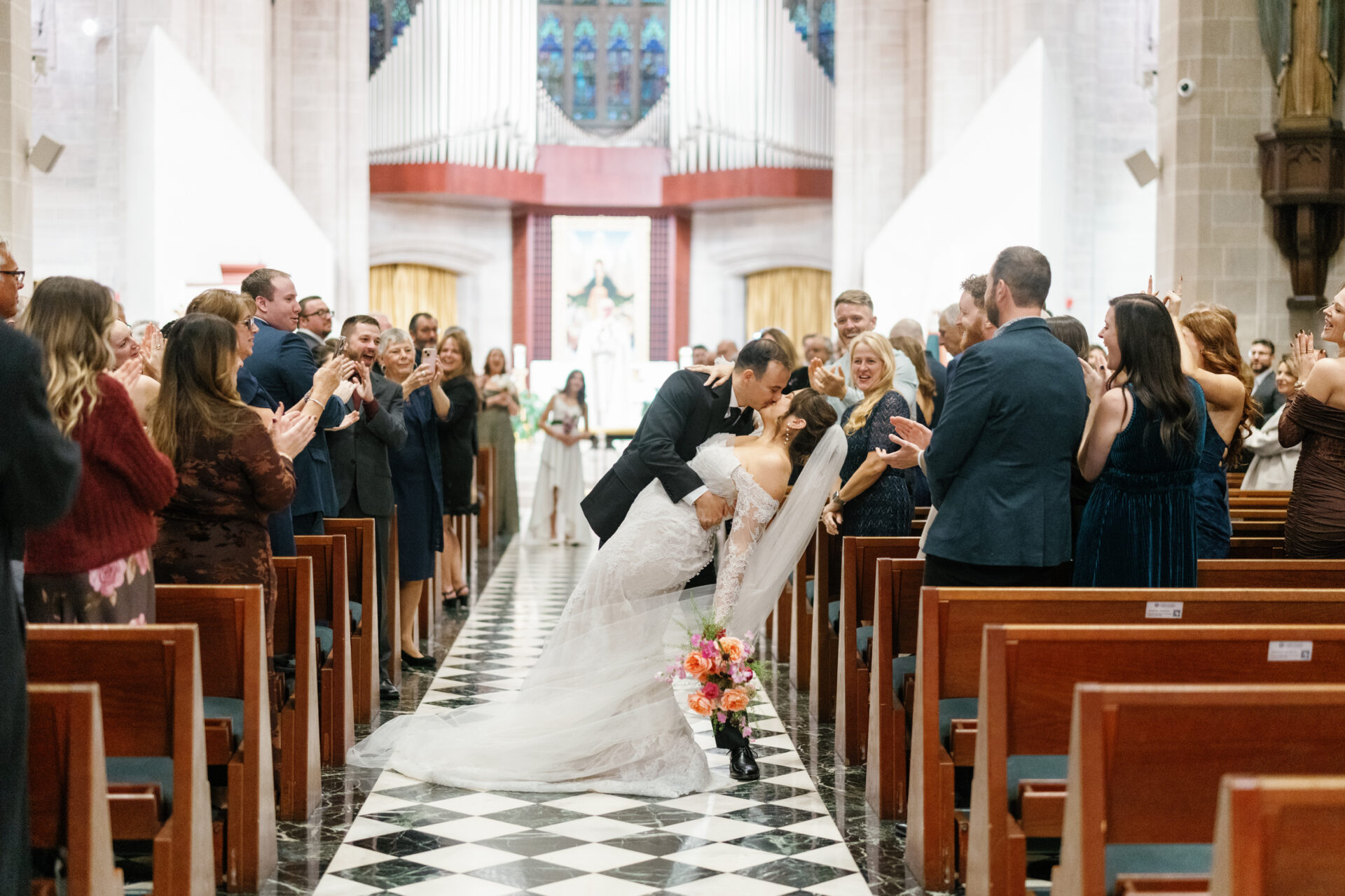 The Bride and the groom with a dip kiss after the ceremony at Blessed Sacrement